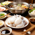 Baby cuttlefish beside a hot pot with dipping sauces