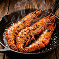 Grilled giant tiger prawns in a cast iron skillet